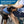 Load image into Gallery viewer, Service dog wearing a stainless steel ID tag beside a seated handler; Quality Stainless Steel, will not rust, bend, or break

