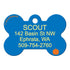 Front view of blue bone-shaped Halloween Snoopy dog ID tag showing yellow engraved sample name SCOUT, address and phone, small orange pumpkin on white background