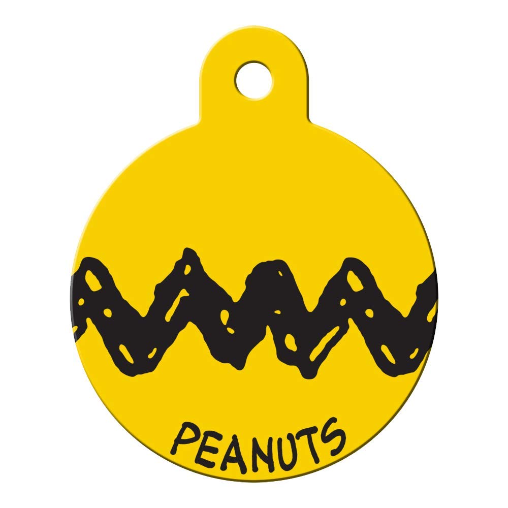 Front view of Peanuts ID tag showing Charlie Brown black zigzag and PEANUTS text on yellow brass tag with white background