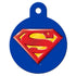 Front view of round Superman dog ID tag showing red-and-yellow S shield on blue enamel; solid brass with UV-cured finish, top attachment hole, personalizable with up to 3 engraved lines