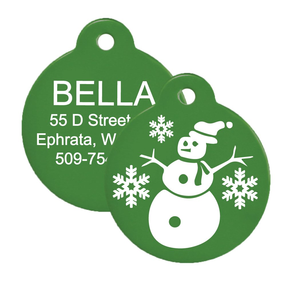 Front and back of green Christmas dog ID tag showing snowman design and sample engraved contact info on white background