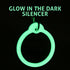 Close-up of Halloween dog ID tag with glow-in-the-dark silencer glowing green; overlaid text GLOW IN THE DARK SILENCER