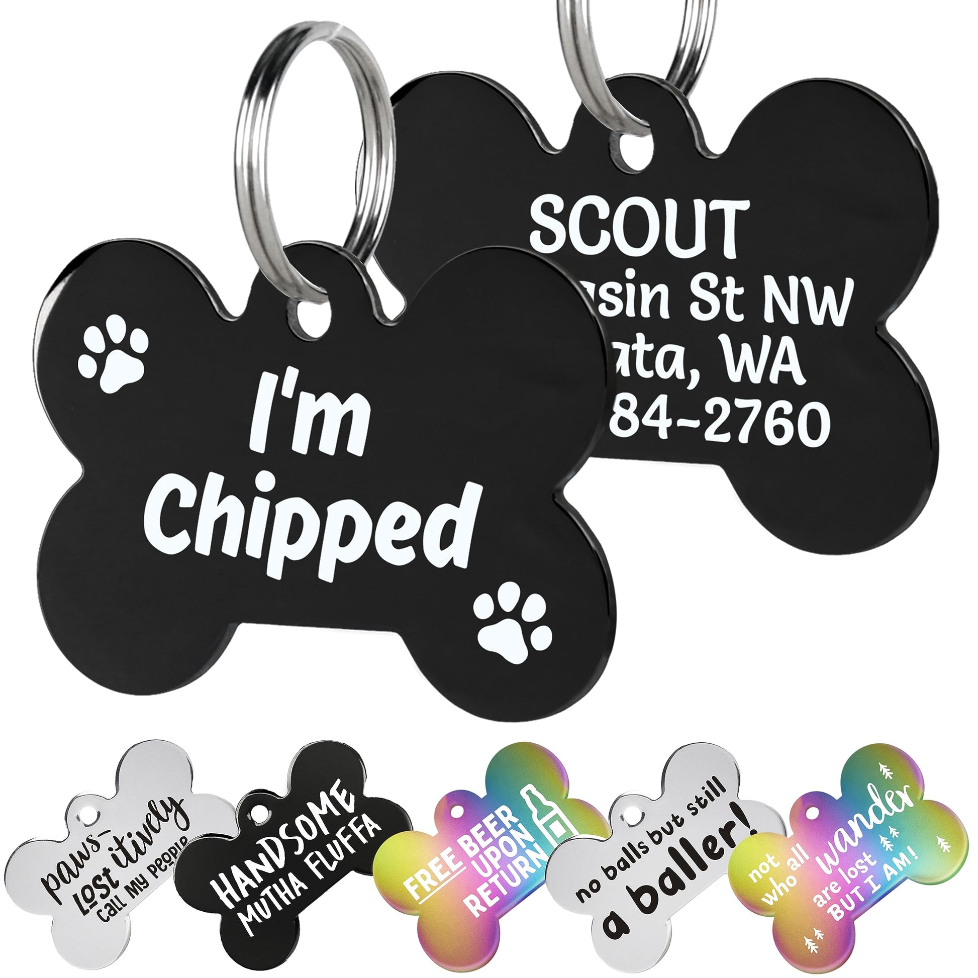 Close-up of black stainless steel bone-shaped dog tag showing white I’m Chipped text, engraved back text, and metal rings