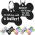 Close-up of two black stainless steel dog tags showing funny white front text and engraved back with split rings
