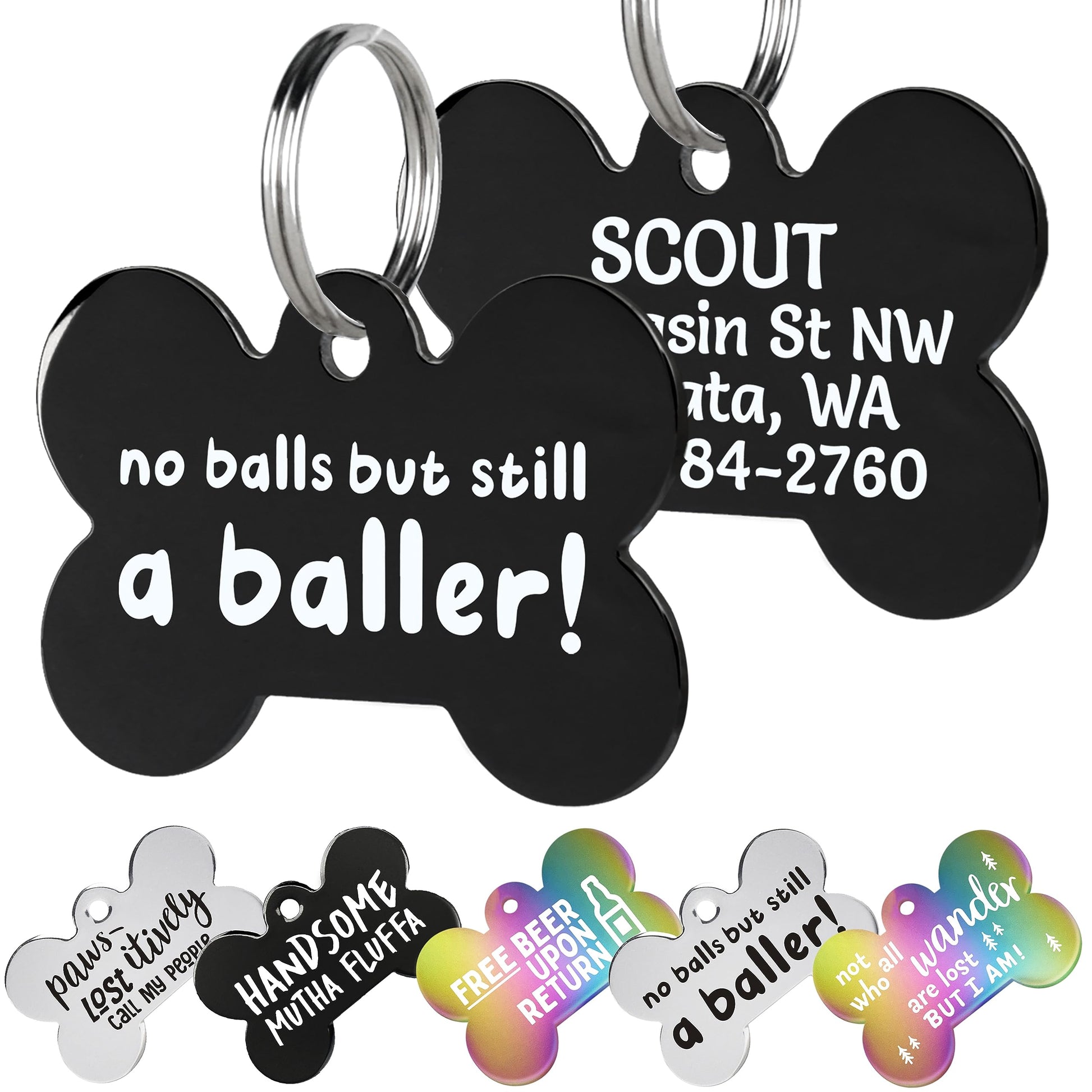 Close-up of two black stainless steel dog tags showing funny white front text and engraved back with split rings