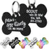 Close-up of two black stainless steel dog ID tags showing white funny front text and engraved back personalization, 1.25 x 1 in, white background