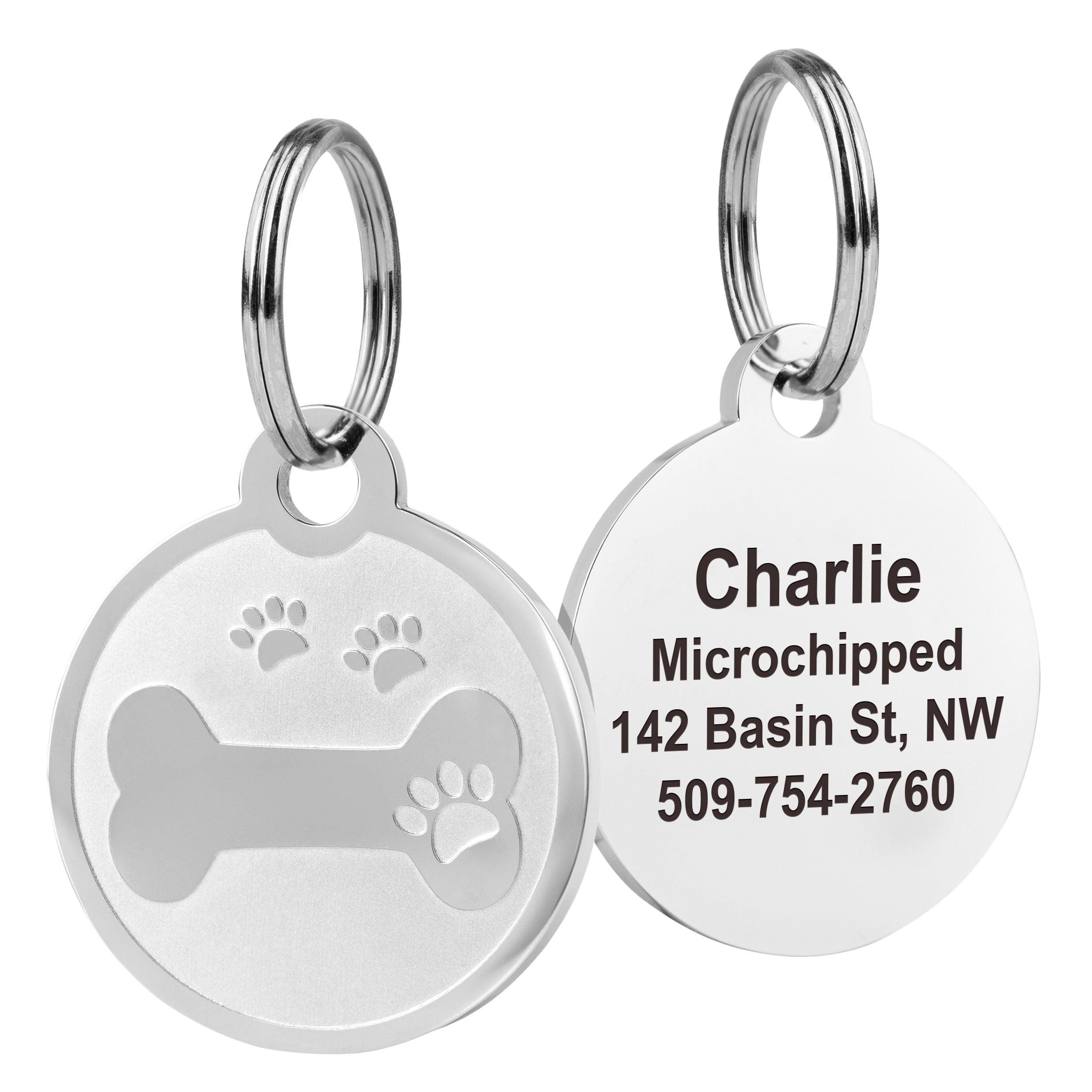 Front and back of 1x1 in stainless steel pet ID tag showing embossed bone and paw and sample engraving of name and phone on white