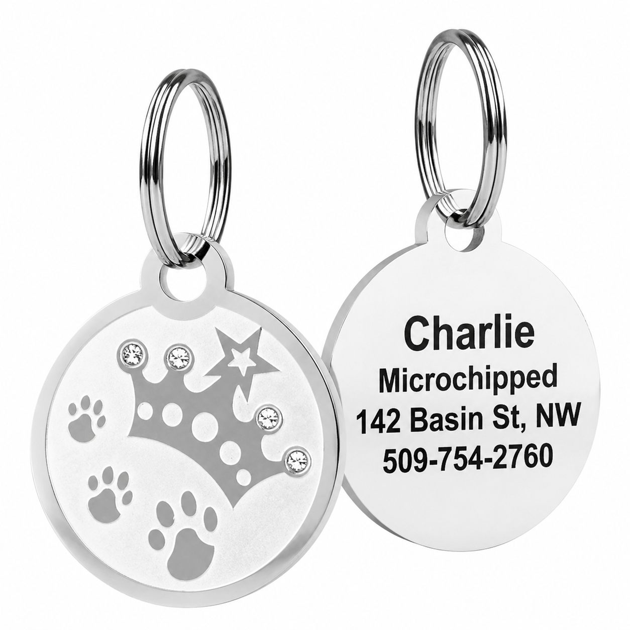 Front and back of Swarovski crystal embossed pet ID tag showing crystal-studded crown, paw cutouts, and engraved name Charlie