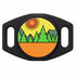 Close-up front of AirTag silicone holder showing engraved forest design and dual slide-on collar slots on black case