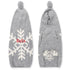 Front and back view of snowflake dog sweater with hood showcasing white snowflake pattern, pompom hood, and red embroidered name on pale gray background