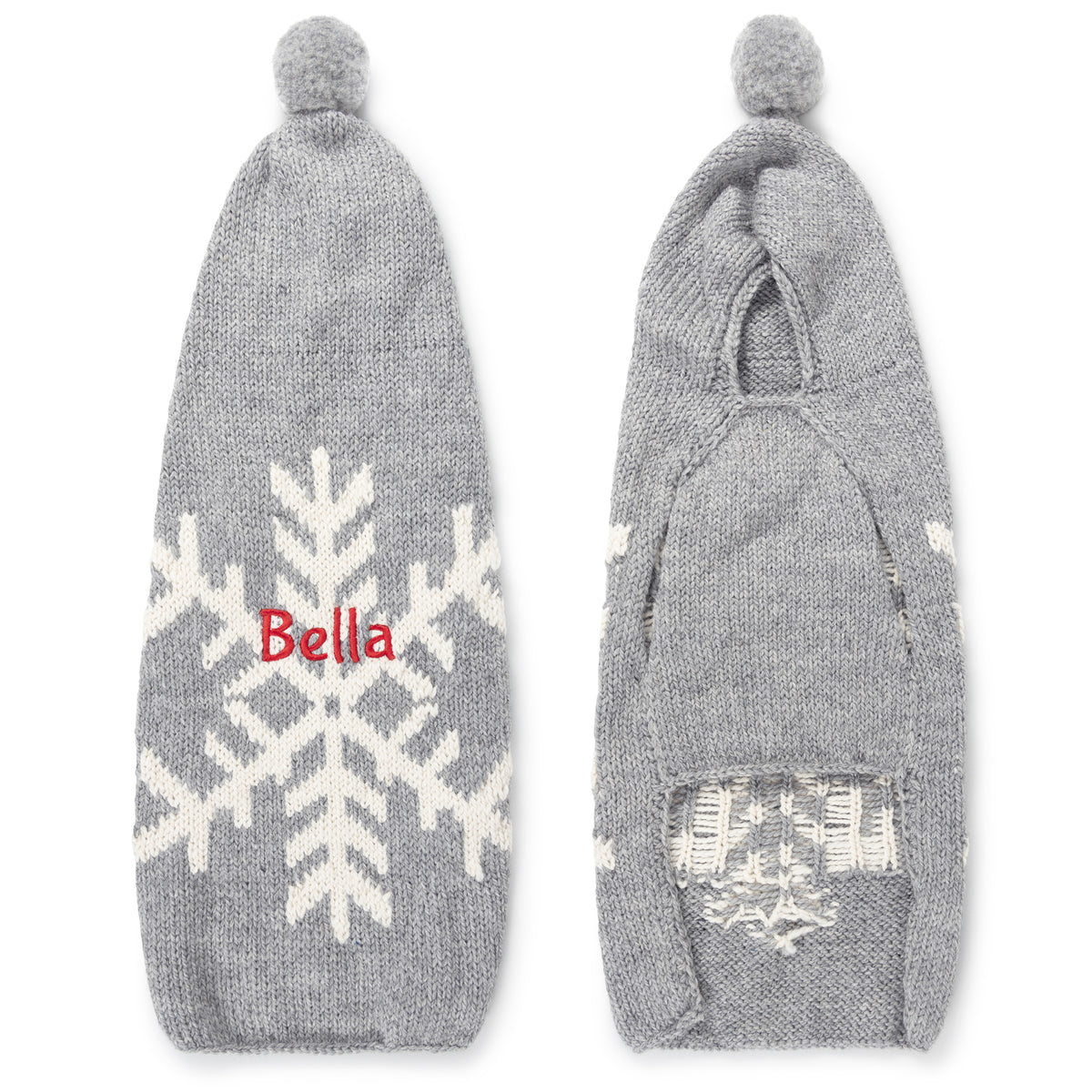Front and back view of snowflake dog sweater with hood showcasing white snowflake pattern, pompom hood, and red embroidered name on pale gray background