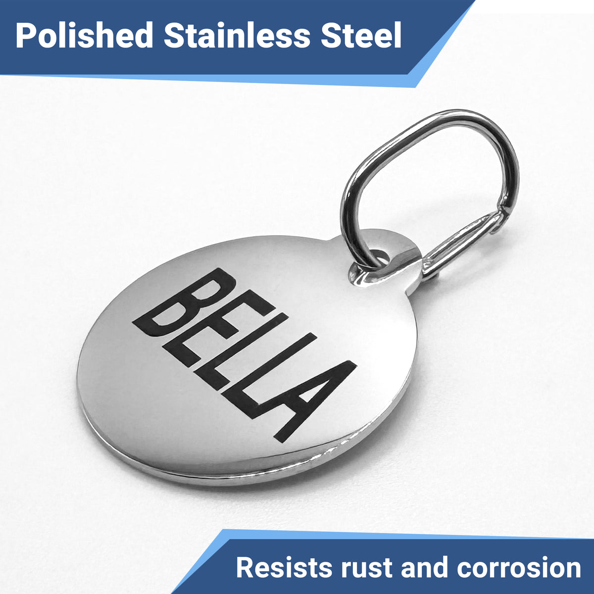 Front view of stainless steel dog tag clip attached to round ID tag engraved 'BELLA', showing spring-loaded snap on white background
