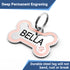 Angled view of bone-shaped stainless steel dog tag showcasing pink enamel border and paw, engraved with name 'BELLA', attached to split ring on white background