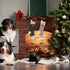 Knit personalized Christmas stockings hanging on a fireplace mantel with two dogs sitting nearby