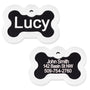 Front and back of black anodized bone pet ID tag showing glow-in-the-dark silencer and sample engraving 'Lucy' on white background