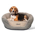 Angled front view of round beige embroidered waterproof dog bed showing embroidered name Oliver and supportive rails