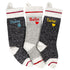 Front view of three hand-knit wool personalized Christmas stockings showing embroidered names and heart or paw motifs on white