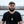 Load image into Gallery viewer, Front view of Embossed Military Dog Tag Necklace Set showcasing a stainless steel tag on a ball chain outdoors
