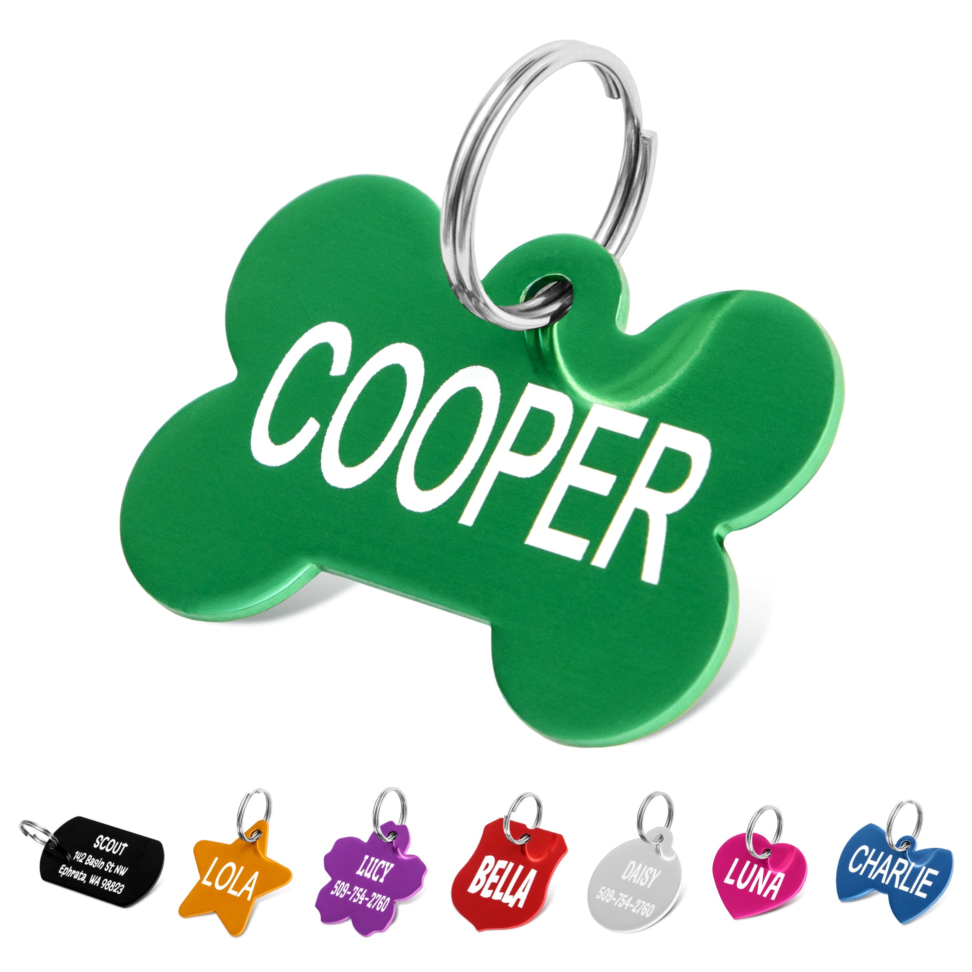 Close-up of green aluminum bone-shaped dog tag engraved with name Cooper and split ring on white background