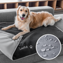 Angled view of personalized gray fleece dog blanket embroidered Luna with paw print, showing water-resistant backing on couch