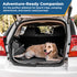 Dog lying on embroidered gray fleece blanket with water-resistant backing in an open car trunk, banner reads Adventure-Ready Companion