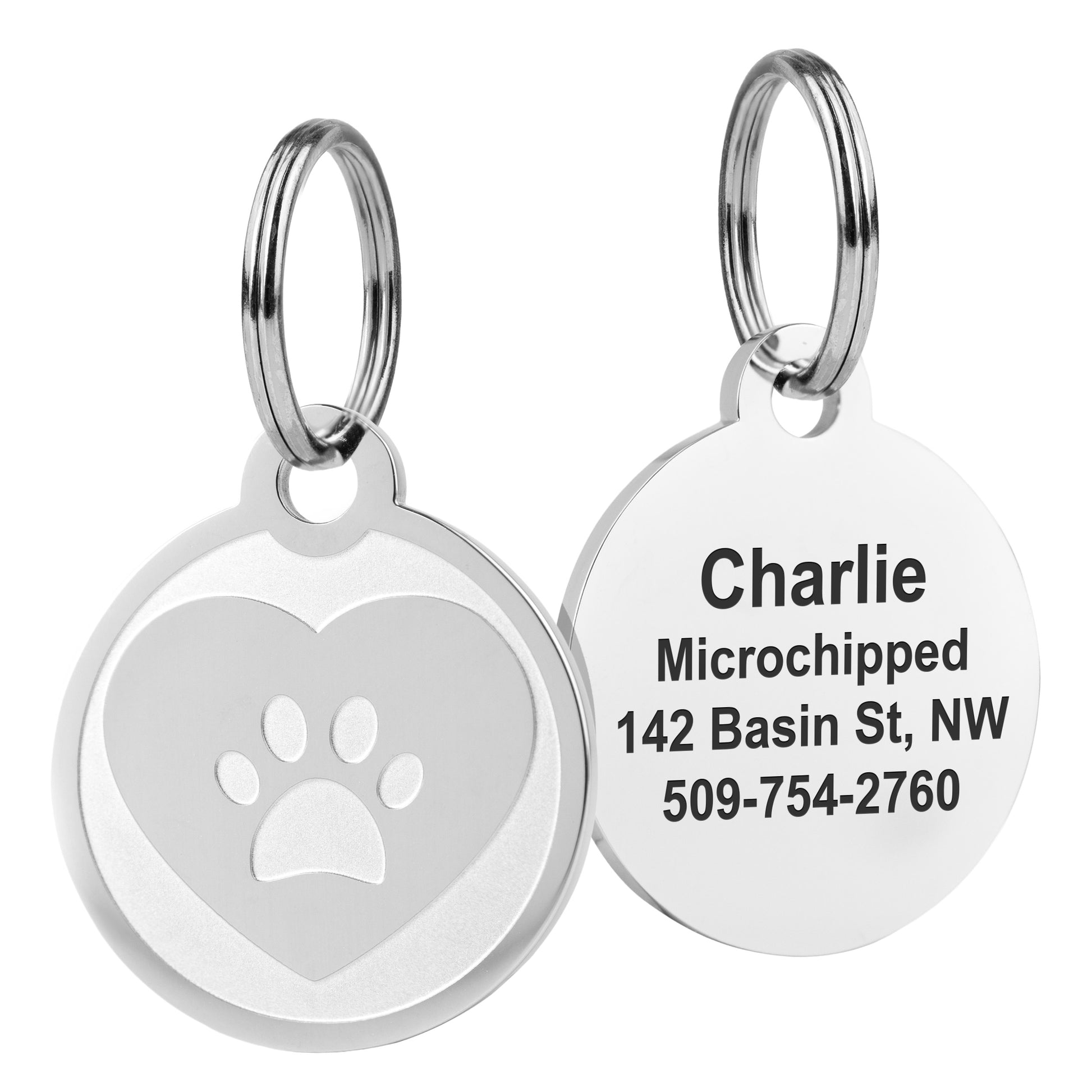 Close-up of two embossed pet ID tags showing paw and heart designs and split-ring attachments on white background