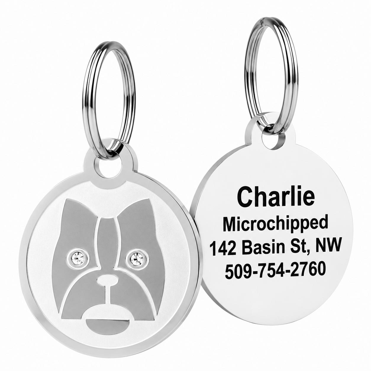 Front and back of Swarovski crystal embossed pet ID tags showcasing crystal-studded crown design and engraved back reading ‘Charlie Microchipped 142 Basin St, NW 509-754-2760’ on white background