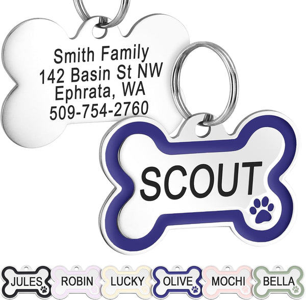 Front view of bone dog ID tag with navy blue enamel paw and personalized engraving on white background