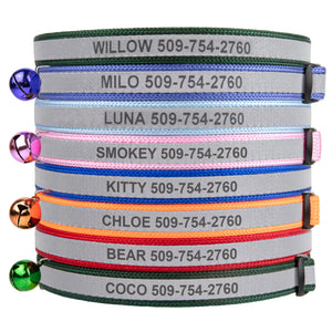 Front view of stacked personalized engraved reflective cat collars in assorted colors with bells and buckles on white
