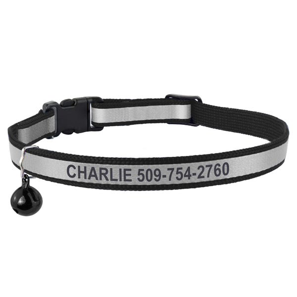 Front view of a black reflective cat collar showcasing engraved name and phone number, breakaway buckle, and bell on white background