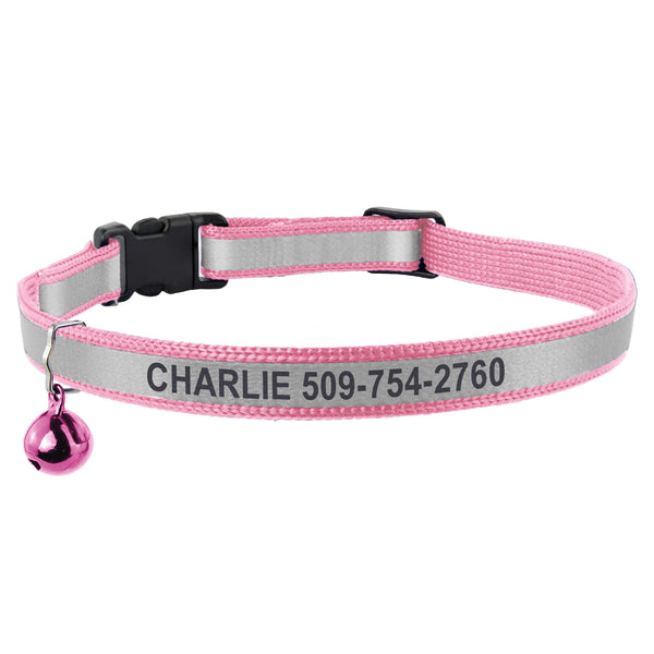 Close-up of a pink engraved reflective cat collar showcasing its breakaway buckle, bell, and CHARLIE 509 754 2760 on white