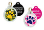 Front view of green and pink camouflage pet ID tags showcasing paw-print design and glow-in-the-dark silencers on white background