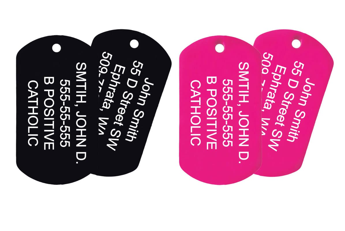 Angled view of Engraved Military Dog Tag Necklace Set with two black and two pink anodized tags showing white laser engraving on white