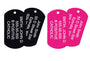 Angled view of Engraved Military Dog Tag Necklace Set with two black and two pink anodized tags showing white laser engraving on white