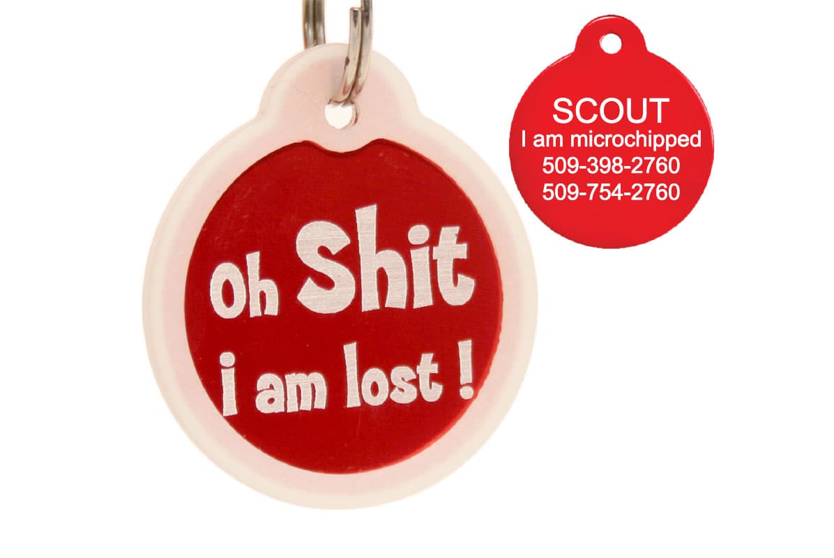 Front view of red circular pet ID tag reading ‘Oh Shit i am lost’ showcasing glow-in-the-dark silencer and metal split ring on white background